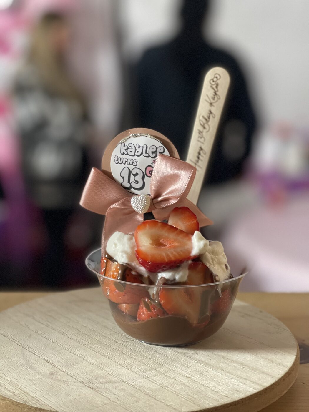 Strawberries and cream cup with a satin bow and personalized topper